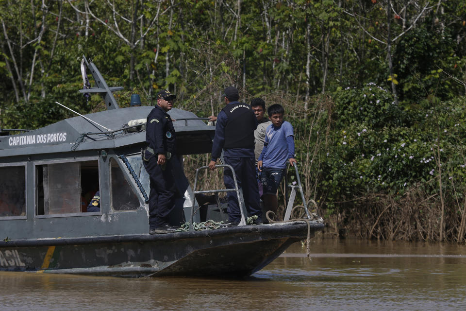 Indigenous people help Navy men in the search for Indigenous expert Bruno Pereira and freelance British journalist Dom Phillips in Atalaia do Norte, Amazonas state, Brazil, Tuesday, June 14, 2022. The search for Pereira and Phillips, who disappeared in a remote area of Brazil's Amazon continues following the discovery of a backpack, laptop and other personal belongings submerged in a river. (AP Photo/Edmar Barros)