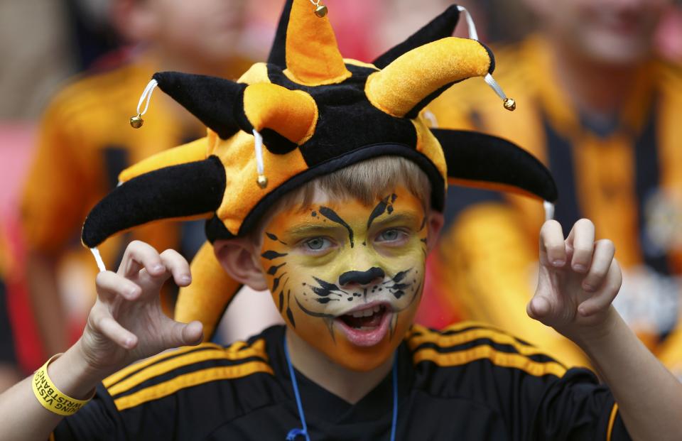 A Hull City supporter poses for a photograph before the start of his team's FA Cup final soccer match against Arsenal at Wembley Stadium in London, May 17, 2014. REUTERS/Eddie Keogh (BRITAIN - Tags: SPORT SOCCER)