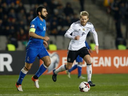 Football Soccer - Azerbaijan v Germany - Group C - World Cup 2018 Qualifiers - Tofig Bahramov Republican stadium, Baku, Azerbaijan - 26/3/17 - Azerbaijan's Rashad Sadygov in action against Germany's Andre Schurrle. REUTERS/David Mdzinarishvili