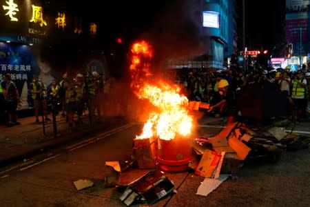 An anti-extradition bill protester sets fire during a protest at Prince Edward in Hong Kong