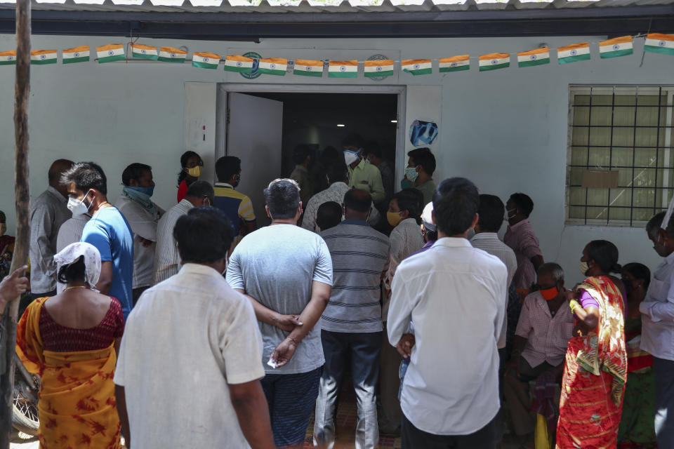 People crowd outside a government hospital to register their names to get vaccinated in Hyderabad, India, Monday, April 19, 2021. India's health system is collapsing under the worst surge in coronavirus infections that it has seen so far. Medical oxygen is scarce. Intensive care units are full. Nearly all ventilators are in use, and the dead are piling up at crematoriums and graveyards. Such tragedies are familiar from surges in other parts of the world — but were largely unknown in India. (AP Photo/Mahesh Kumar A.)