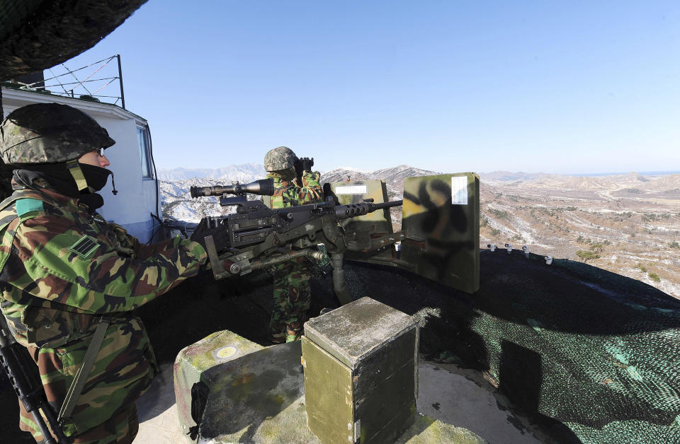 FILE - In this Dec. 19, 2011, file photo, South Korean army soldiers stand guard after a news reporting about the death of North Korean leader Kim Jong Il at a guard post in the demilitarized zone between South and North Korea in Goseong, South Korea. South Korean troops were engaged in an operation near the heavily fortified border with North Korea on Wednesday, Nov. 4, 2020, after detecting "unidentified personnel" there, the South's military said. (Korea Pool via AP, File)