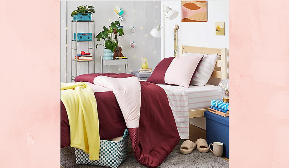 Girl's dorm room shown looking toward bed