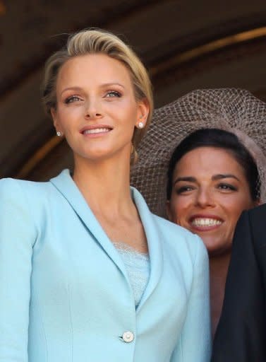 Princess Charlene of Monaco (L) poses on the balcony next to her Maid of Honour Donatella Knecht de Massy after her civil wedding to Prince Albert II of Monaco at the Prince's Palace in Monaco