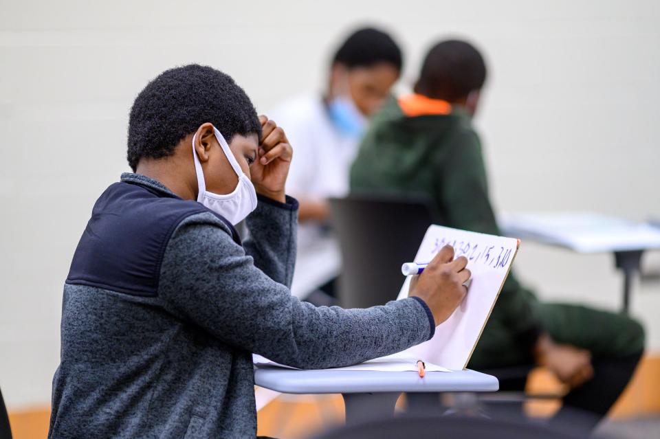 Sixth-grader Jeremiah Anderson works a problem in a math class at Brown Community Learning Center in South Bend.