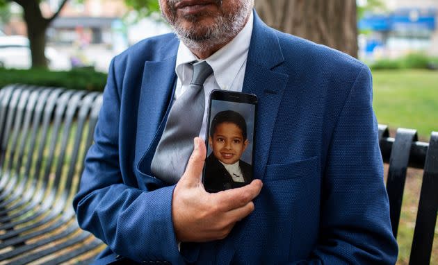 Ahmed Daoud holds a photo of his son Adel Daoud as a child.