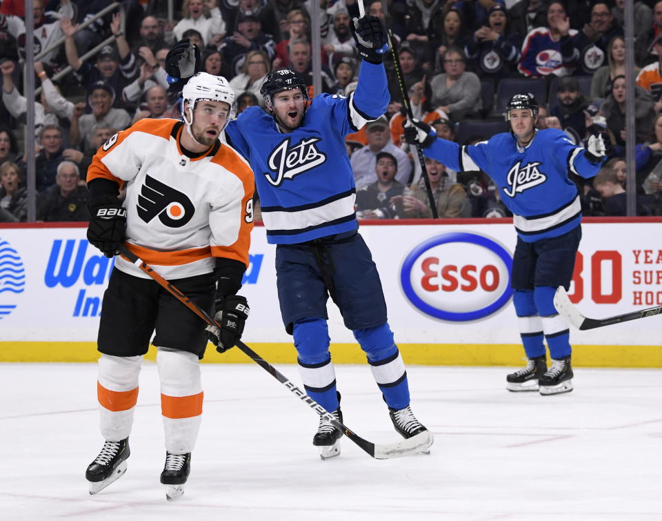 Winnipeg Jets' Logan Shaw (38) celebrates his goal as Philadelphia Flyers' Ivan Provorov (9) looks on during second-period NHL hockey game action in Winnipeg, Manitoba, Sunday, Dec. 15, 2019. (Fred Greenslade/The Canadian Press via AP)