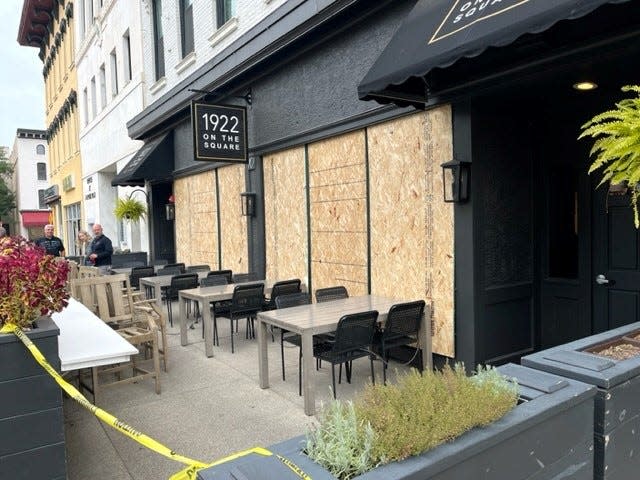 Windows on the 1922 On The Square restaurant were boarded up on Monday following weekend vandalism on North Park Place.