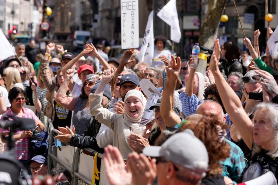 Julian Assange supporters react outside the High Court in London (AP)