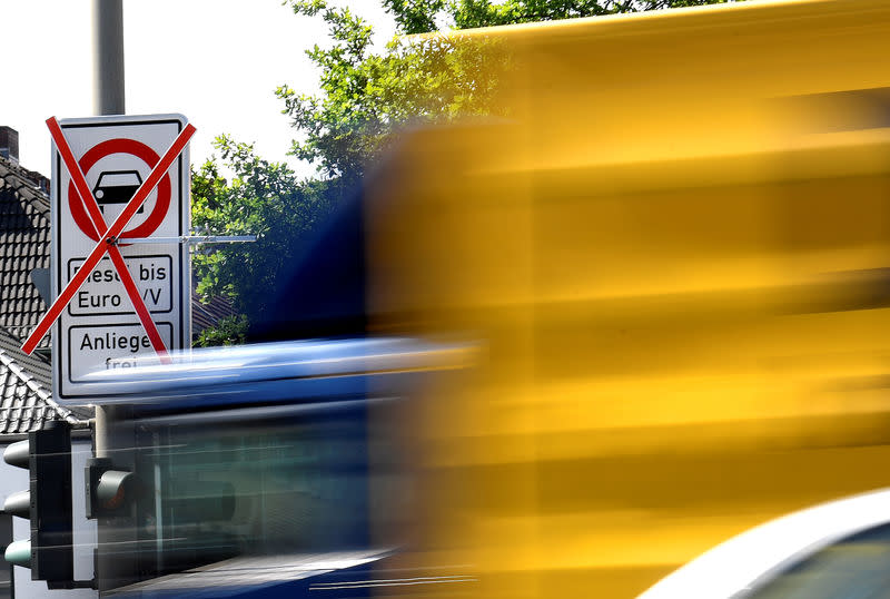 A truck passes a traffic sign showing a ban on diesel cars at the Max-Brauer Allee in downtown Hamburg, Germany May 23, 2018. REUTERS/Fabian Bimmer