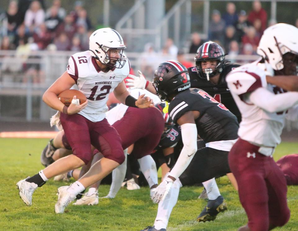 Mishawaka quarterback Brady Fisher (12) runs with the ballduring the Mishawaka vs. NorthWood football game Friday, Sept. 29, 2023, at Jim Andrews Field in Nappanee.