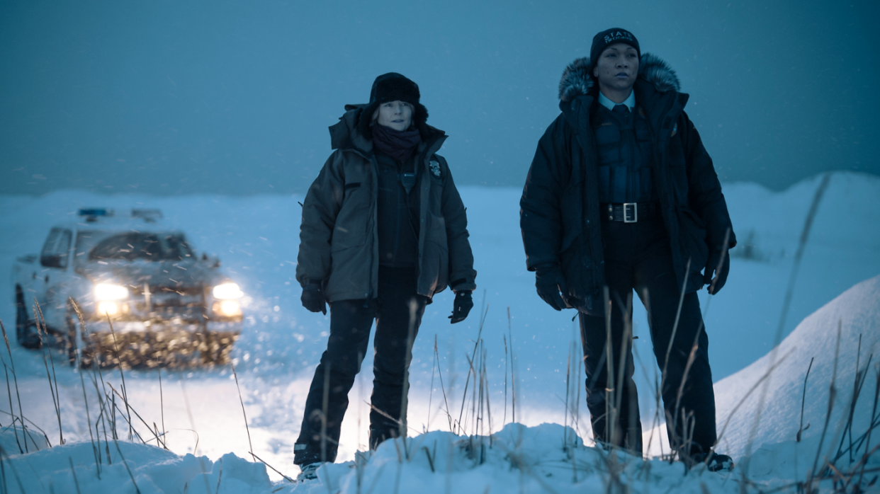 two people standing in the snow