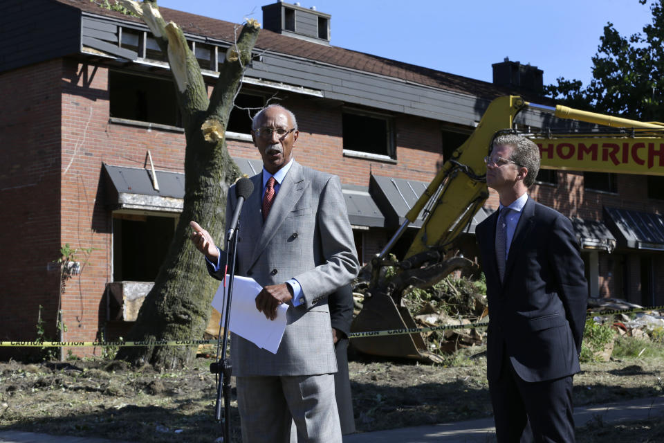 Detroit Mayor Dave Bing, left, speaks while United States Department of Housing and Urban Development Secretary Shaun Donovan listens at the first stage of demolishing the Frederick Douglass Homes in Detroit, Wednesday, Sept. 4, 2013. The graffiti-covered complex comprising several city blocks is better known as the Brewster projects. A $6.5 million emergency federal grant covers the initial phase of demolition and cleanup, and officials say the city will be eligible for more money when that’s completed. The federal money comes at a crucial time for the city, which is overseen by a state-appointed emergency manager and in July became the nation’s largest city to file for bankruptcy. (AP Photo/Paul Sancya)