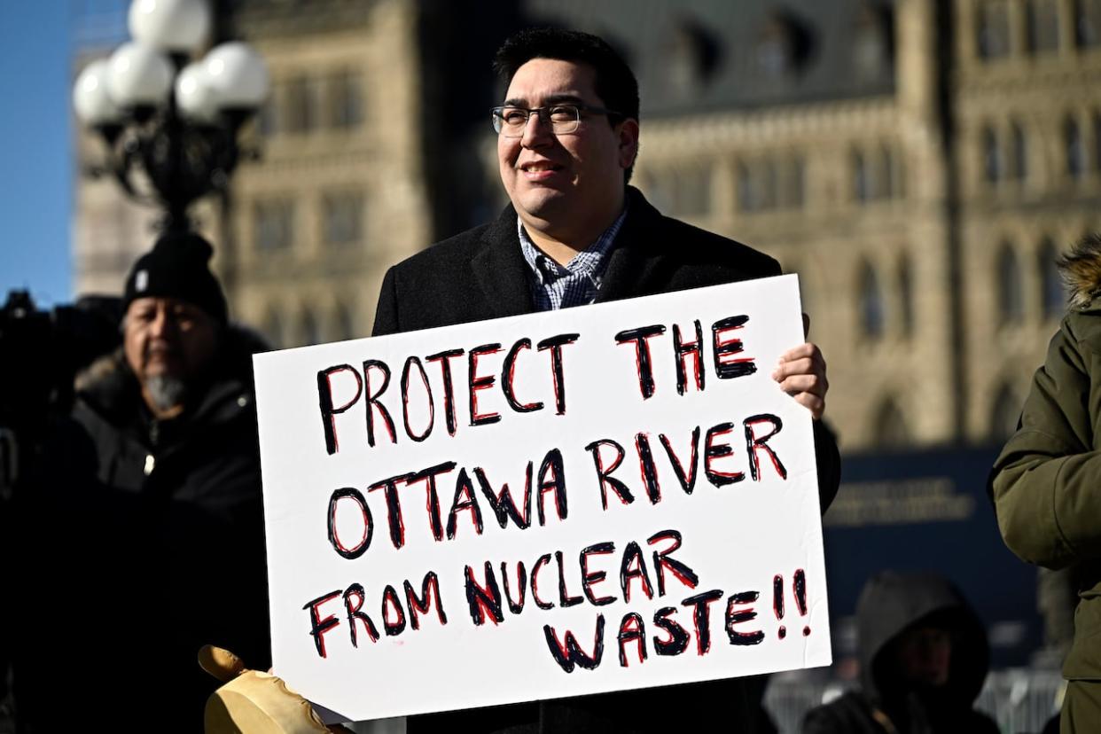 Kitigan Zibi Anishinabeg Chief Dylan Whiteduck participates in a rally against the Near Surface Disposal Facility (NSDF) project at the Canadian Nuclear Laboratories Chalk River site, on Parliament Hill in Ottawa, on Wednesday. (Justin Tang/The Canadian Press - image credit)