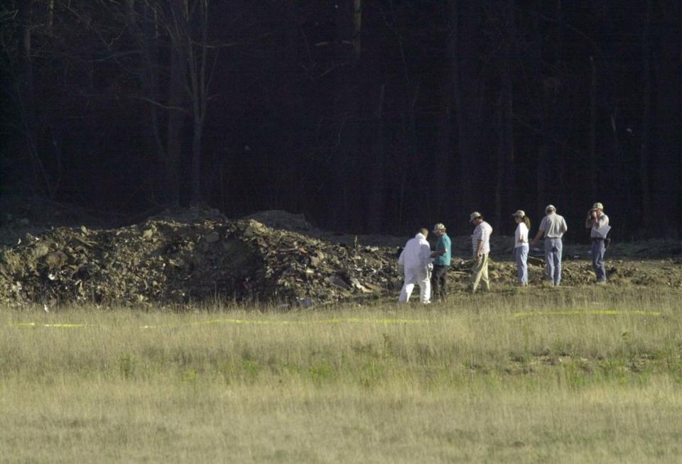 <p>Photo by DAVID MAXWELL/AFP via Getty Images</p><p>Officials examine the crater at the crash site of United Airlines Flight 93 in Shanksville, Pennsylvania. </p>