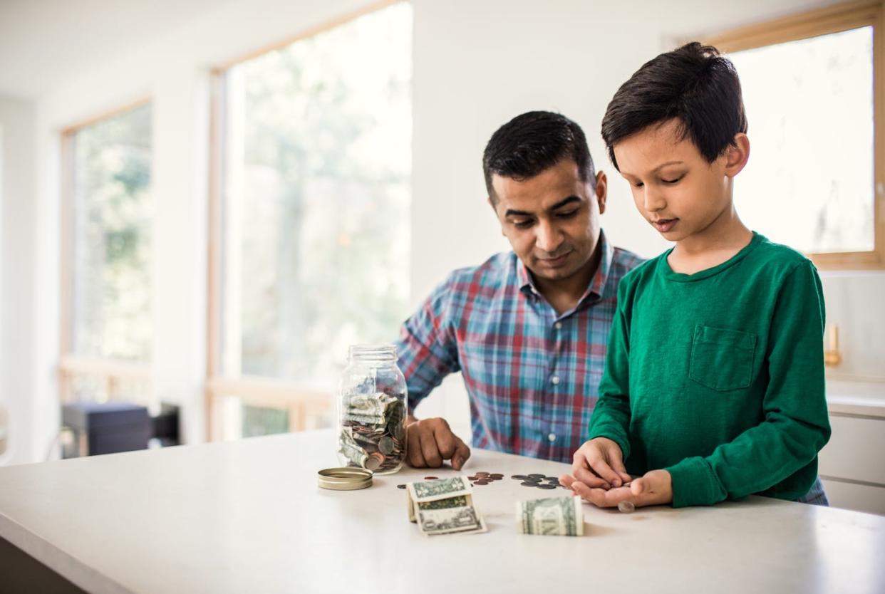 <span class="caption">A 529 plan can pay for up to $10,000 a year for tuition at K-12 schools.</span> <span class="attribution"><a class="link " href="https://www.gettyimages.com/detail/photo/father-and-son-counting-money-at-home-royalty-free-image/924565162?adppopup=true" rel="nofollow noopener" target="_blank" data-ylk="slk:MoMo Productions/DigitalVision via Getty Images;elm:context_link;itc:0;sec:content-canvas">MoMo Productions/DigitalVision via Getty Images</a></span>