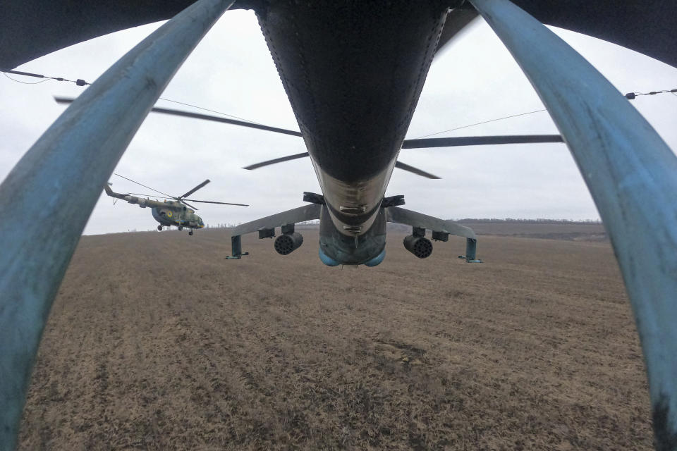 Ukrainian Mi-24 and Mi-8 helicopters fly towards Russian positions during a combat mission in Donetsk region, Ukraine, Sunday, March 19, 2023. (AP Photo/Evgeniy Maloletka)