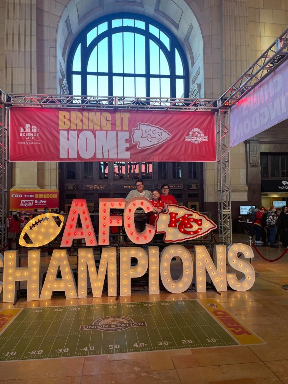 Jessica Tangen of Riverside, left, visited a Chiefs display at Union Station with daughter, Kyla, and mother, Lee. Tangen died while attending Chiefs practice Sunday.