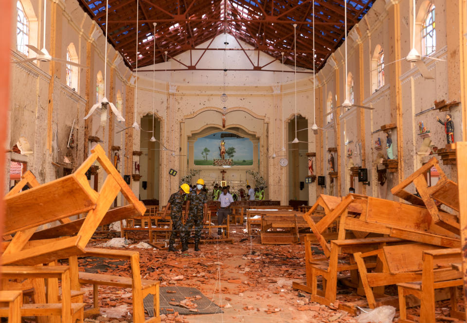 Sri Lankan military officers conduct inspections inside the St. Sebastians church where a bomb blast took place. Source: Getty