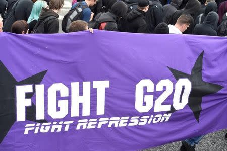 Protestors carry a banner during a demonstration against the new temporary prison for the G20 Summit in Hamburg, Germany, June 24, 2017. REUTERS/Fabian Bimmer