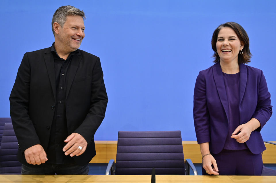 Co-leader of Germany's Greens and the party's candidate for chancellor Annalena Baerbock and the Greens' party co-leader Robert Habeck arrive to address a news conference in Berlin, Germany, Monday, Sept. 27, 2021. Following Sunday's election leaders of the German parties were meeting Monday to digest a result that saw Merkel’s Union bloc slump to its worst-ever result in a national election and appeared to put the keys to power in the hands of two opposition parties. Both Social Democrat Olaf Scholz and Armin Laschet, the candidate of Merkel's party, laid a claim to leading the next government. ( John MacDougall/Pool via AP)