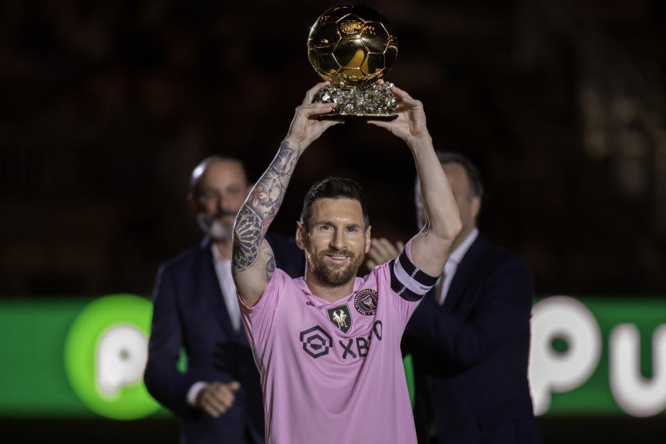 FORT LAUDERDALE, FL - NOVEMBER 10: Inter Miami FC forward Lionel Messi smiles smiles as he shows the fans his 8th Ballon d'Or award during the Noche D'Or soccer match between New York City FC and Inter Miami FC at the DRV PNK Stadium on November 10, 2023 in Fort Lauderdale, FL. (Photo by Doug Murray/Icon Sportswire via Getty Images)