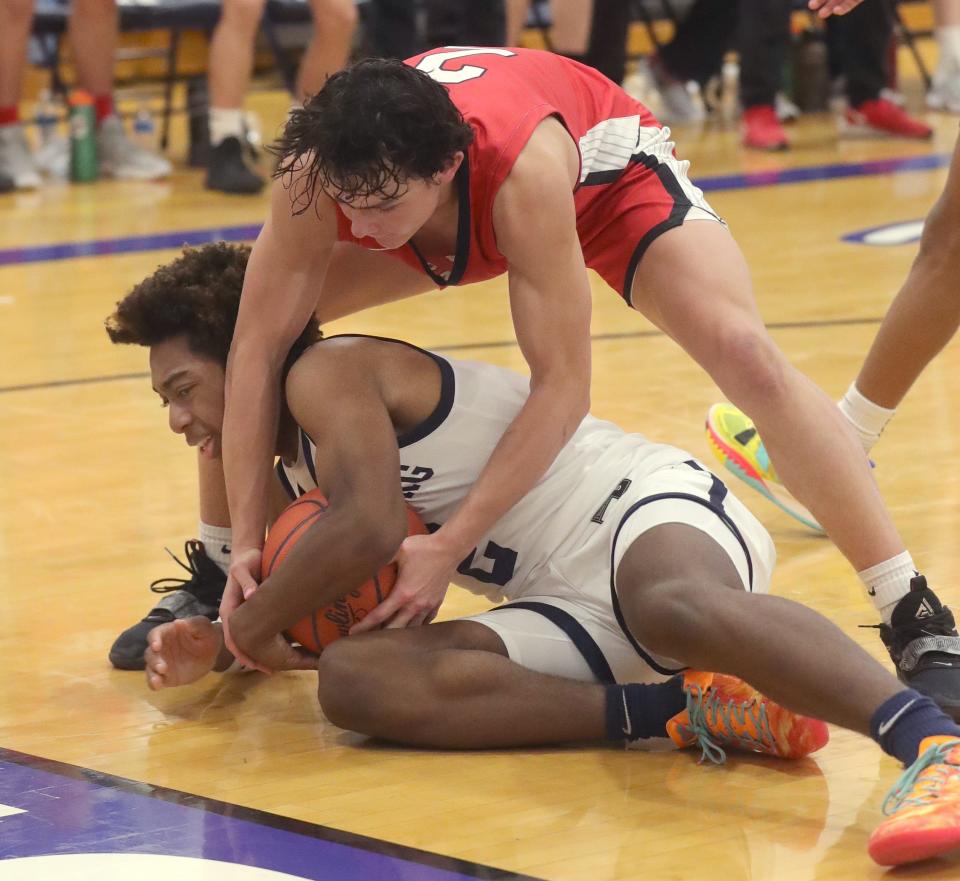 Wadsworth's Caden Madigan, top, and Twinsburg's Reggie Bussey scramble after a loose inbounds pass during the fourth quarter of  the Tigers' 70-66 Suburban League National Conference win Friday night. [Phil Masturzo/Beacon Journal]