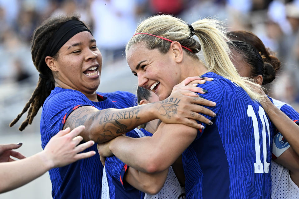 United States midfielder Lindsey Horan (10) celebrates with forward Mia Fishel, left, and other teammates after scoring against Colombia during the second half of an international friendly soccer match Sunday, Oct. 29, 2023, in San Diego. (AP Photo/Alex Gallardo)