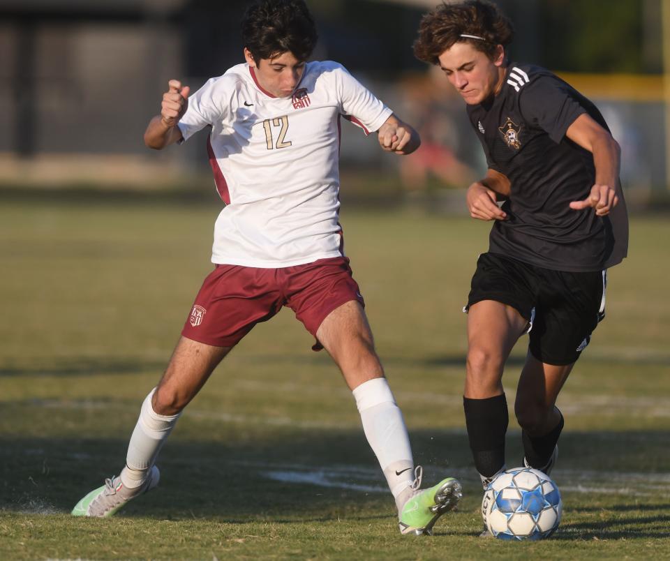 Ashley's Nick Cenatiempo, left, controls the ball at Topsail in Hampstead, N.C., Tuesday, September 28, 2021.  [MATT BORN/STARNEWS]   