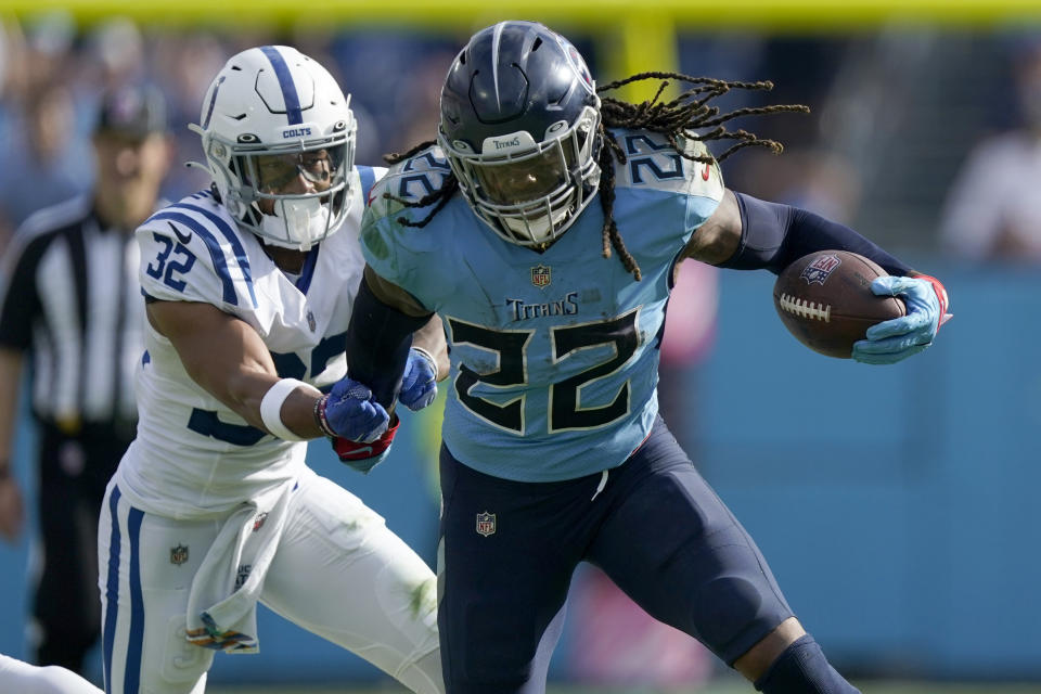 Tennessee Titans running back Derrick Henry (22) runs with the ball as Indianapolis Colts safety Julian Blackmon (32) defends during the second half of an NFL football game Sunday, Oct. 23, 2022, in Nashville, Tenn. (AP Photo/Mark Humphrey)