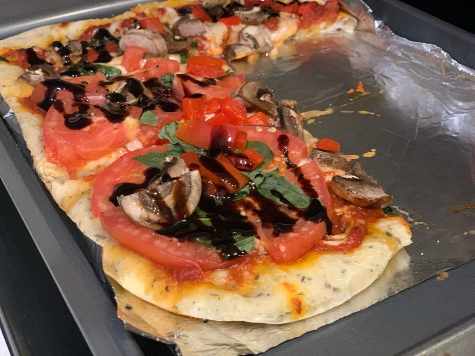 cooked veggie flatbread on tray lined with tin foil