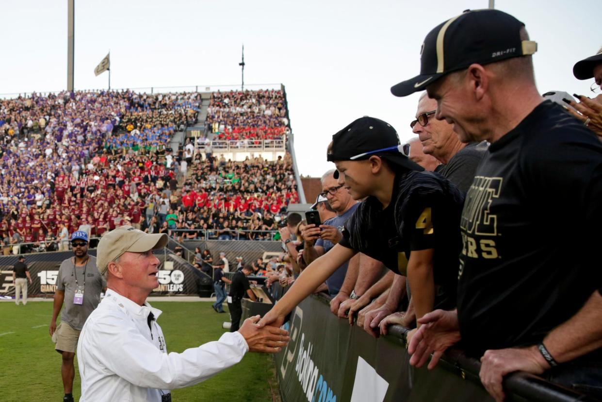 Purdue president Mitch Daniels greets spectators during the first quarter of a NCAA football game, Saturday, Sept. 14, 2019 at Ross-Ade Stadium in West Lafayette.