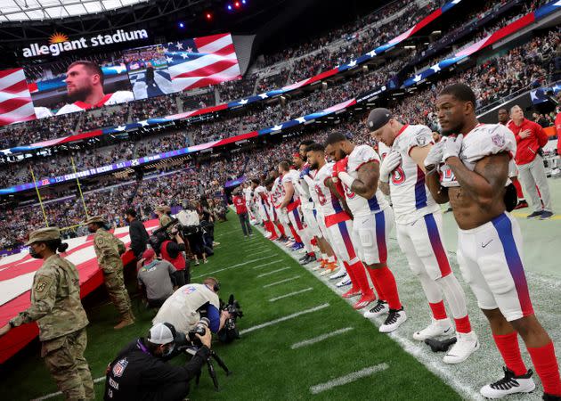 AFC players stand on the sideline as the national anthem is performed before the 2022 NFL Pro Bowl at Allegiant Stadium. (Photo: Ethan Miller via Getty Images)