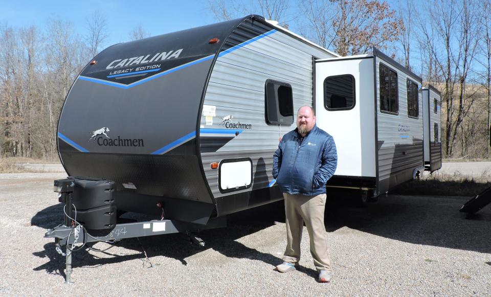 Chris Park, general sales manager at Meyer's RV in Mount Morris, stands by a camper that has slide out compartments. When checking your RV for the upcoming camping season, remember to check the roof area of the slide outs as well.