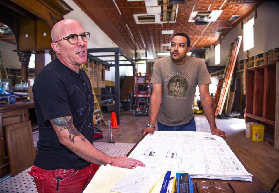 Maynard James Keenan, the singer for the band Tool, left, looks over architectural plans with executive chef Chris Smith during the construction of Keenan's wine-tasting room and osteria in Cottonwood Oct. 13, 2016. The owner of Merkin Vineyards Osteria has plans to expand his wine business even further in the Cottonwood area.