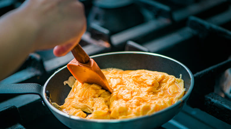 scrambled eggs cooking in pan