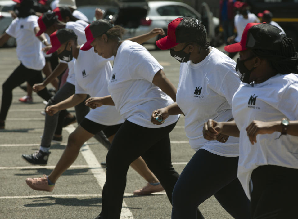 People dance to Jerusalema in Johannesburg, Thursday, Sept. 24, 2020. South Africans of all walks of life are dancing to the rousing anthem, which has sparked a global trend, to lift their spirits amid the battle against COVID-19. (AP Photo/Denis Farrell)