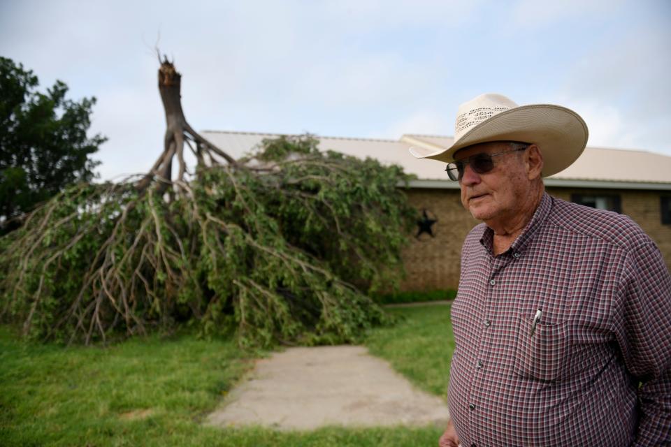 Rex Glover stands in front of the tree on his home after a tornado, Thursday, June 22, 2023, in Matador, Texas. "By the time I got out of my recliner and into my closet it was already over," Glover said.