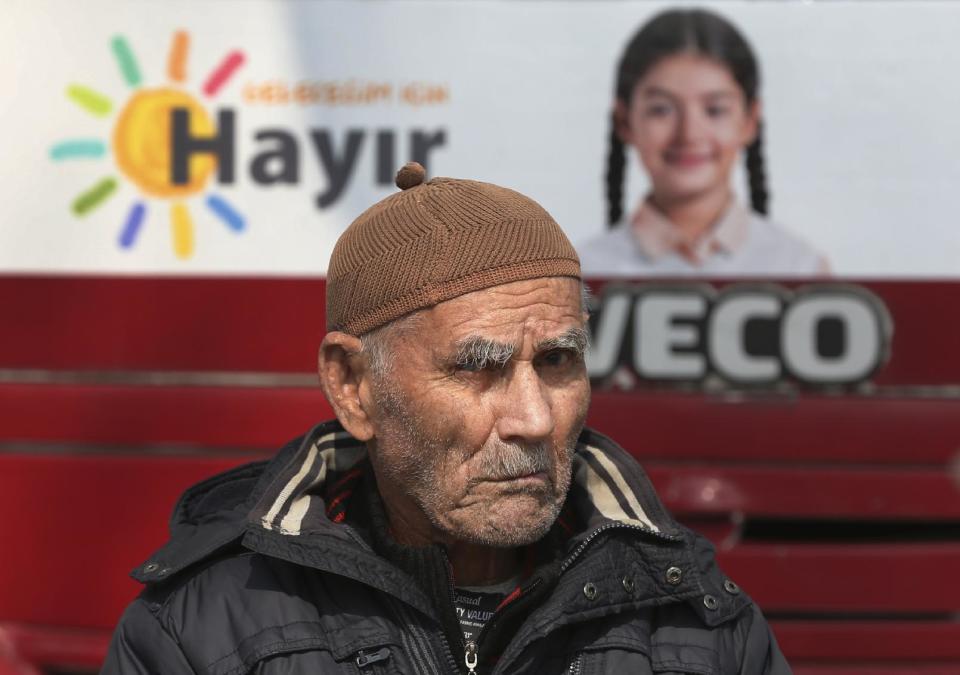 In this Wednesday, March 15, 2017 photo, a Turkish supporter of the 'NO' vote for the upcoming referendum sits at a campaign tent in central Istanbul. The entire Turkish referendum campaign has been biased and unfair, those opposed to expanding the president’s powers say, noting they have been hampered by a lack of TV airtime, threats, violence, arbitrary detentions and even sabotage. Those reports come even as Turkish President Recep Tayyip Erdogan himself has slammed European countries for not letting his ministers campaign on their soil for the April 16 vote on expanding his powers. (AP Photo/Lefteris Pitarakis)