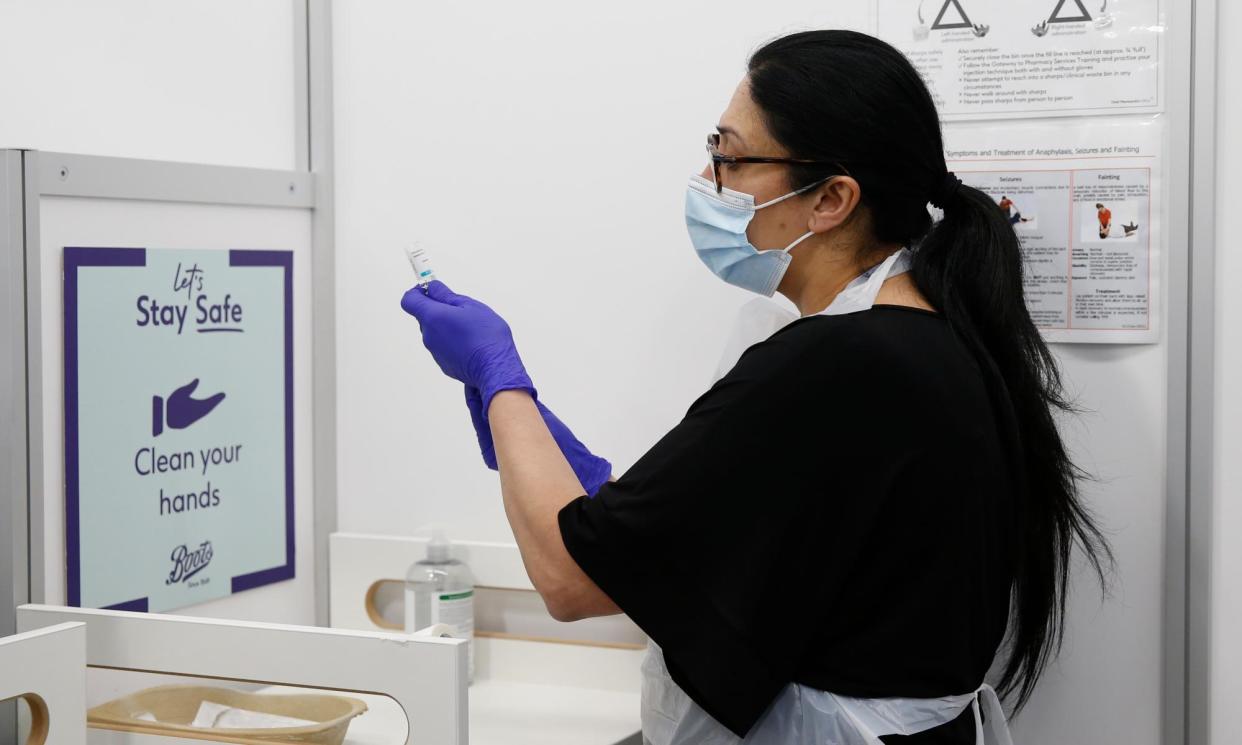 <span>An NHS worker prepares a Covid vaccine at a Boots pharmacy in London.</span><span>Photograph: Hollie Adams/Getty Images</span>