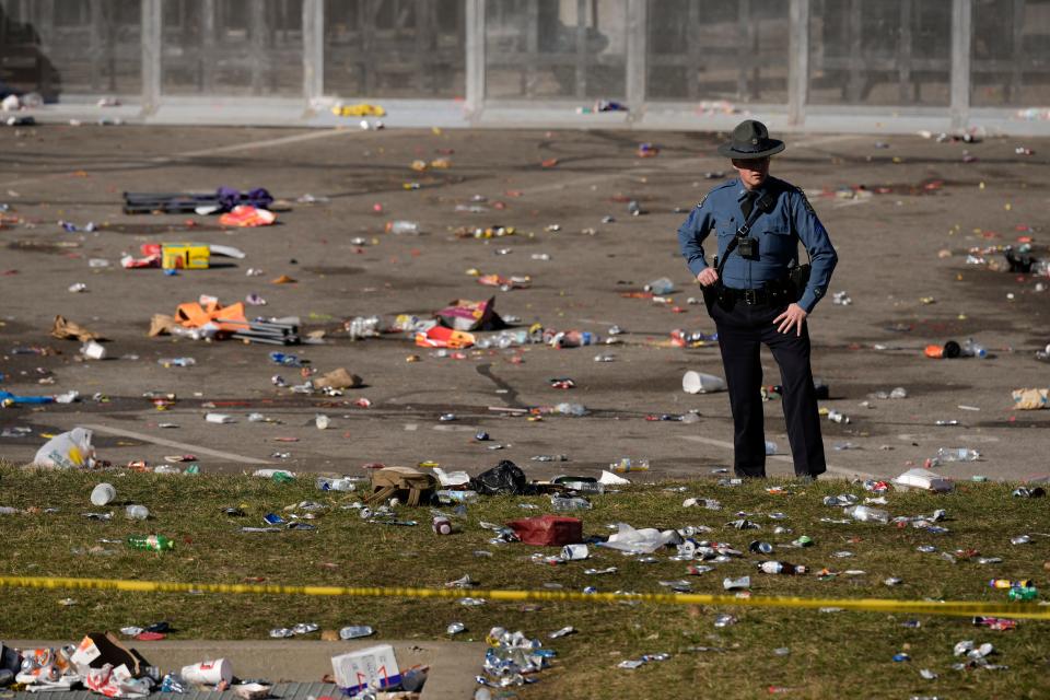 A law enforcement officer looks around the scene after an incident following the Kansas City Chiefs victory parade in Kansas City, Mo., Wednesday, Feb. 14, 2024.