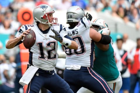 New England Patriots quarterback Tom Brady (12) attempts a pass against the Miami Dolphins during the first half at Hard Rock Stadium - Credit: Jasen Vinlove/USA TODAY