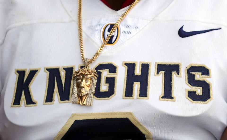 A religious chain hangs around the neck of linebacker Rickey Williams during the Hoban football media day, Aug. 7, 2023.