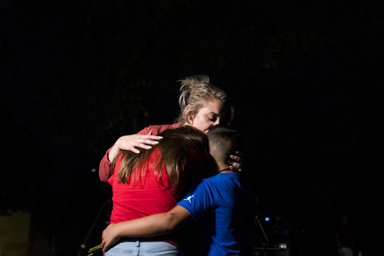 A woman embraces two children outside Willie de Leon Civic Center in Uvalde, Texas, on May 24, 2022. (Eric Thayer / Bloomberg via Getty Images)