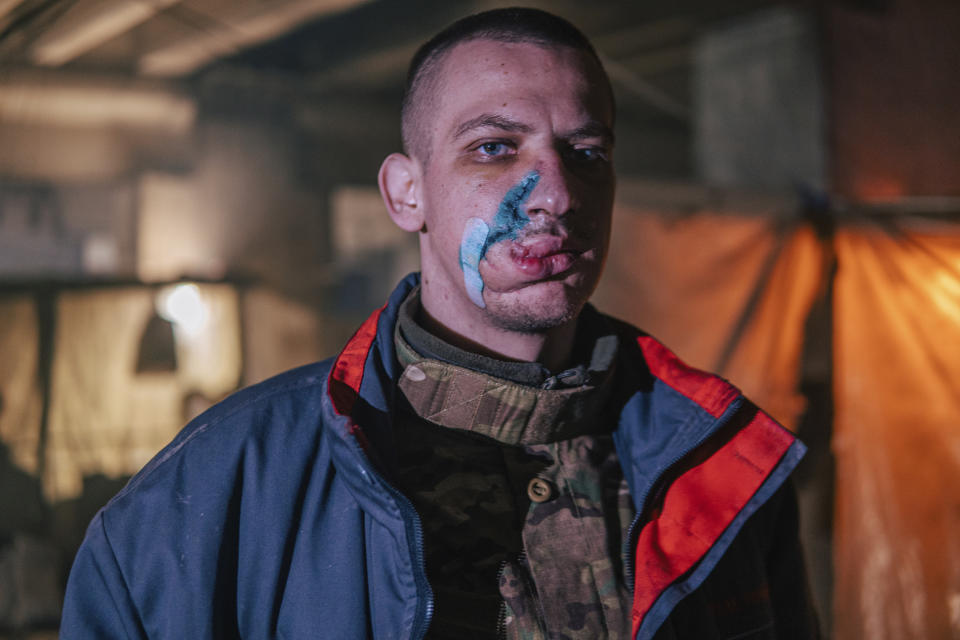 In this photo provided by Azov Special Forces Regiment of the Ukrainian National Guard Press Office, an Azov Special Forces Regiment's serviceman, injured during fighting against Russian forces, poses for a photographer inside the Azovstal steel plant in Mariupol, Ukraine, Tuesday, May 10, 2022. (Dmytro 'Orest' Kozatskyi/Azov Special Forces Regiment of the Ukrainian National Guard Press Office via AP)