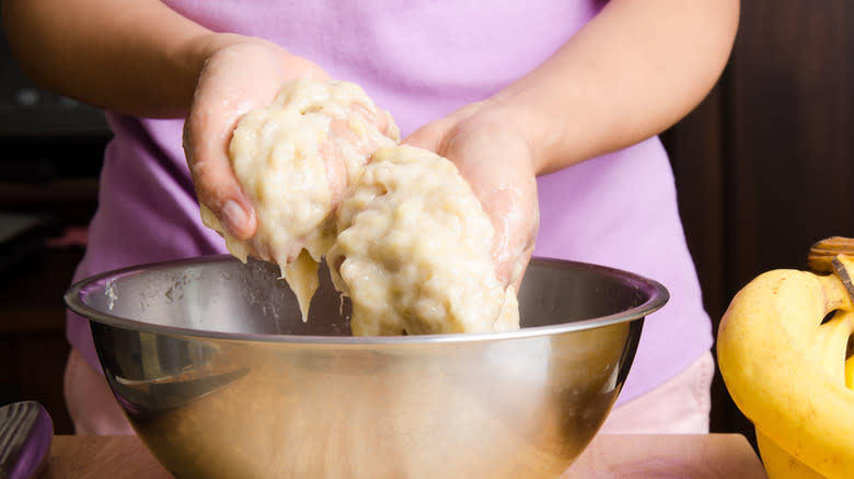 person holding mashed bananas