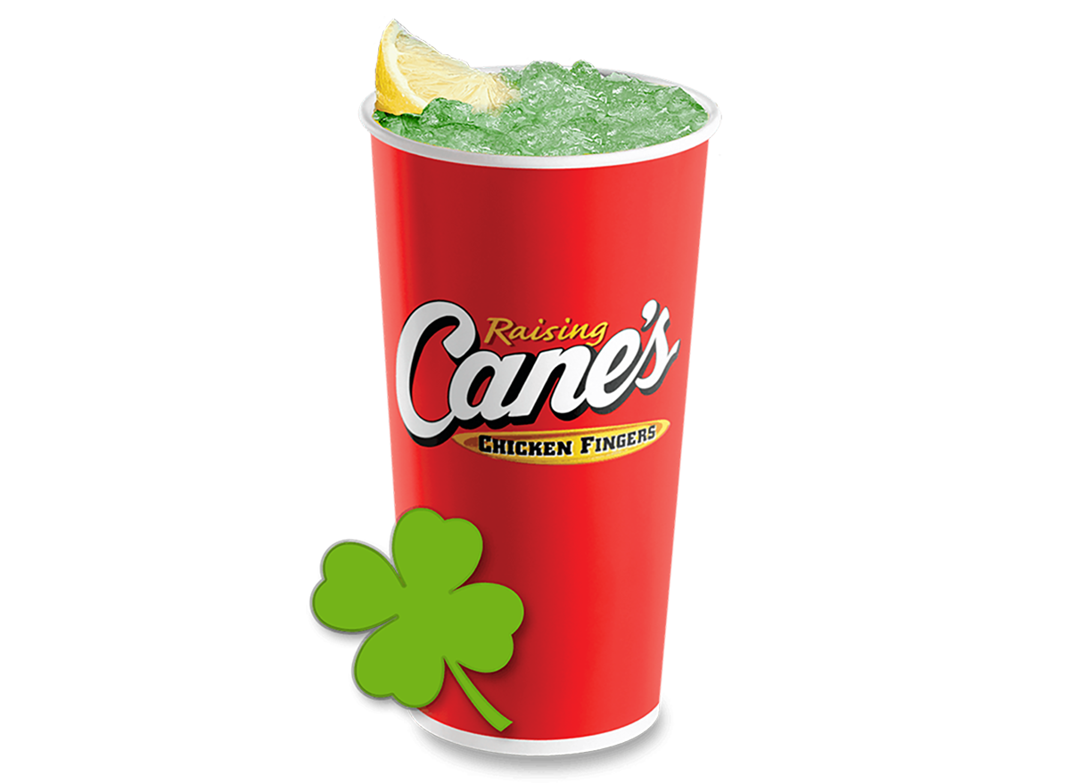 Green-colored Leprechaun Lemonade in a big red cup at Raising Cane's restaurant