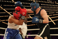 <p>Anthony Davilla (red) of the 79th Precinct in Brooklyn covers as cadet Paul Altamore (blue) throws a punch in the Brooklyn vs. Police Academy match during the NYPD Boxing Championships at the Hulu Theater at Madison Square Garden on March 15, 2018. (Gordon Donovan/Yahoo News) </p>