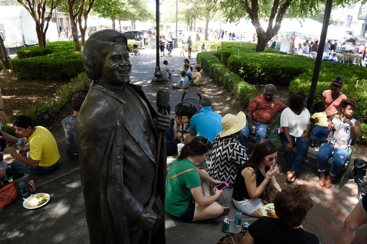 FILE - People eat food in the shade near the James Brown statue on Broad Street at Arts in the Heart of Augusta on Saturday, Sept. 19, 2015. JON-MICHAEL SULLIVAN/STAFF