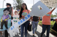 <p>Maria Angelica Ramirez carries a large key reading “My Dream” during a protest outside the office of Sen. Marco Rubio, R-Fla., in support of Deferred Action for Childhood Arrivals (DACA), and Congress passing a clean Dream Act, Monday, Jan. 22, 2018, in Doral, Fla. (Photo: Lynne Sladky/AP) </p>